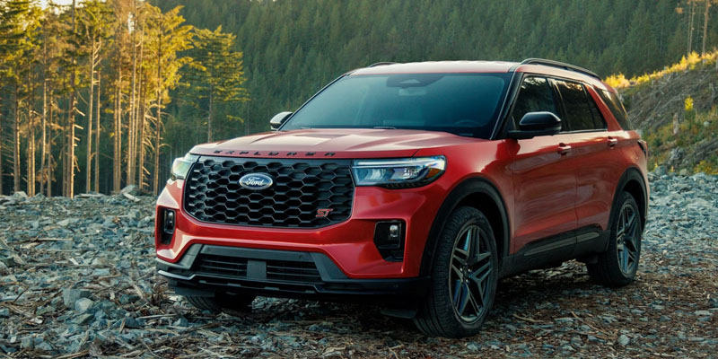 Red 2026 Ford Explorer on road side in mountains