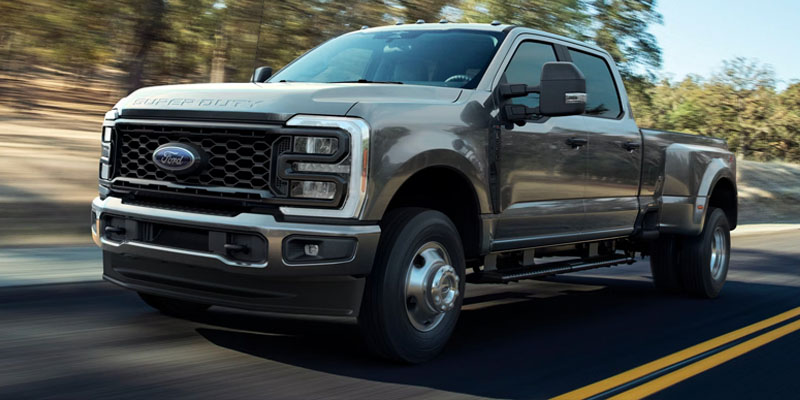 Silver Ford Super Duty F-350 truck cruising on road